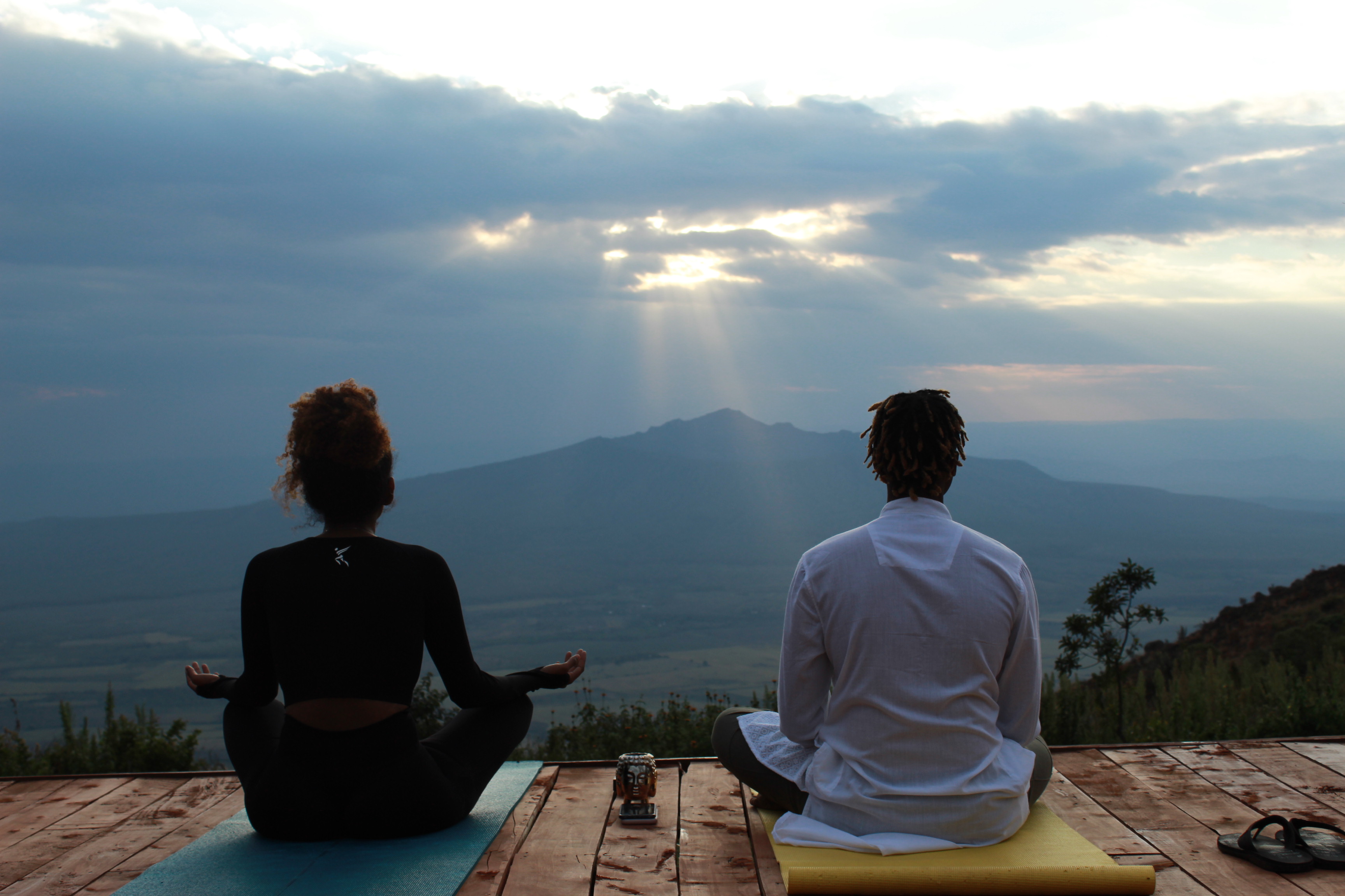 Sunrise yoga session overlooking the mountains at Mawingu Camp